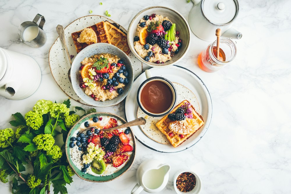 Breakfast ingredients and fresh fruit arranged on a table