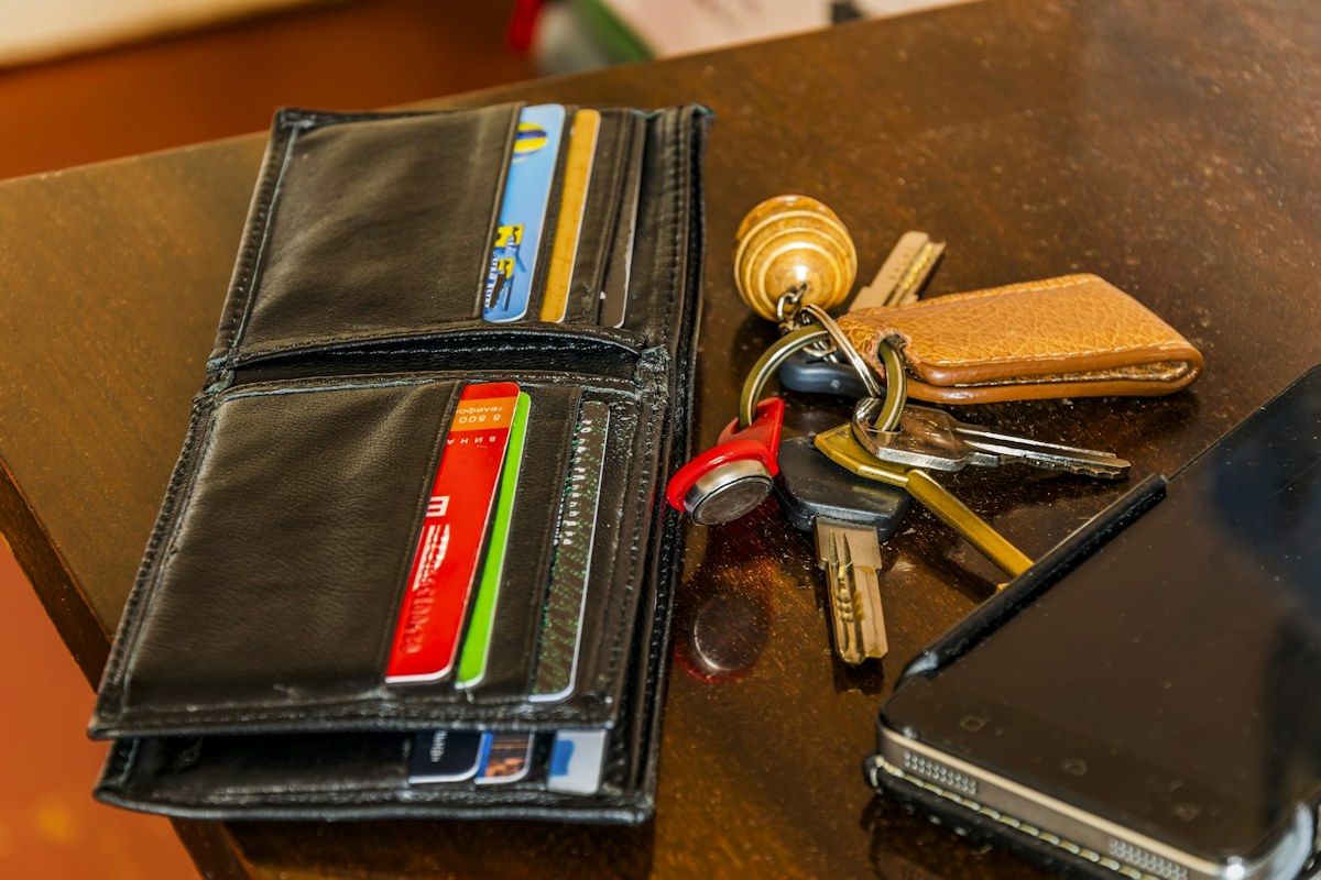 Keys and a wallet resting on a wooden table