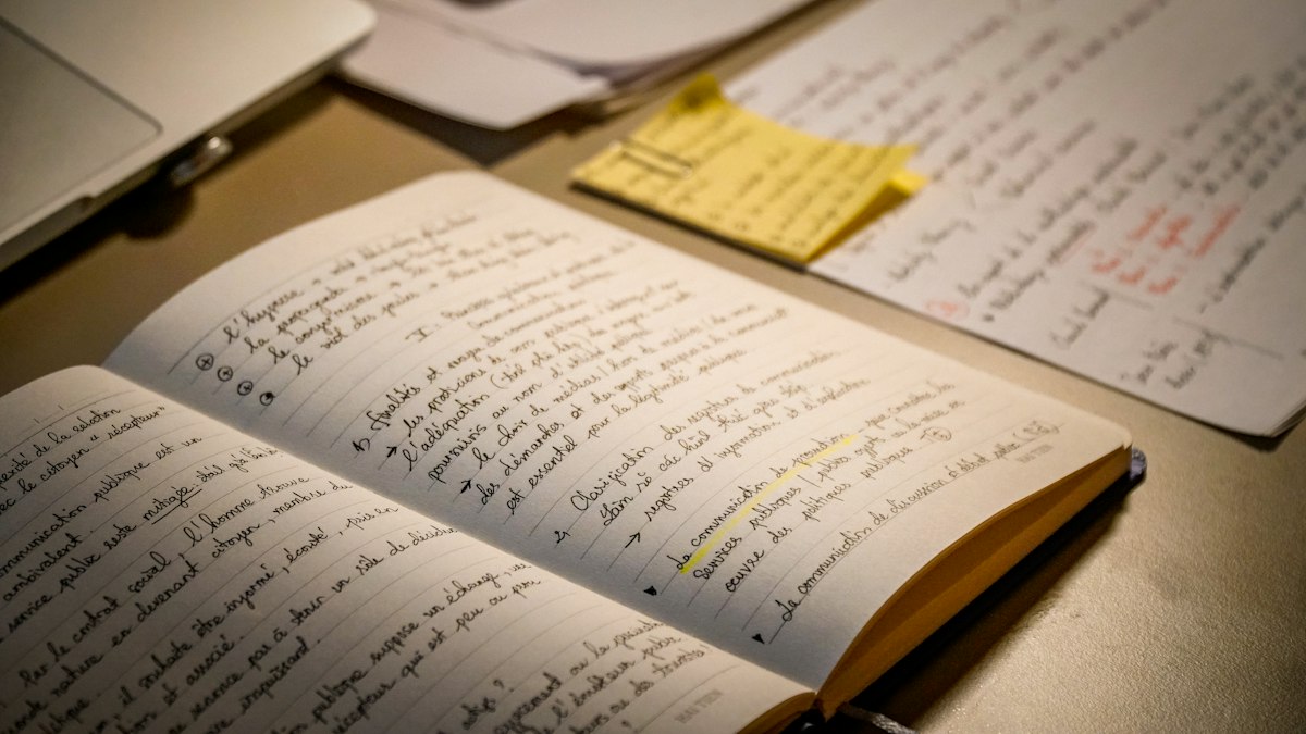 An open notebook filled with handwritten text
