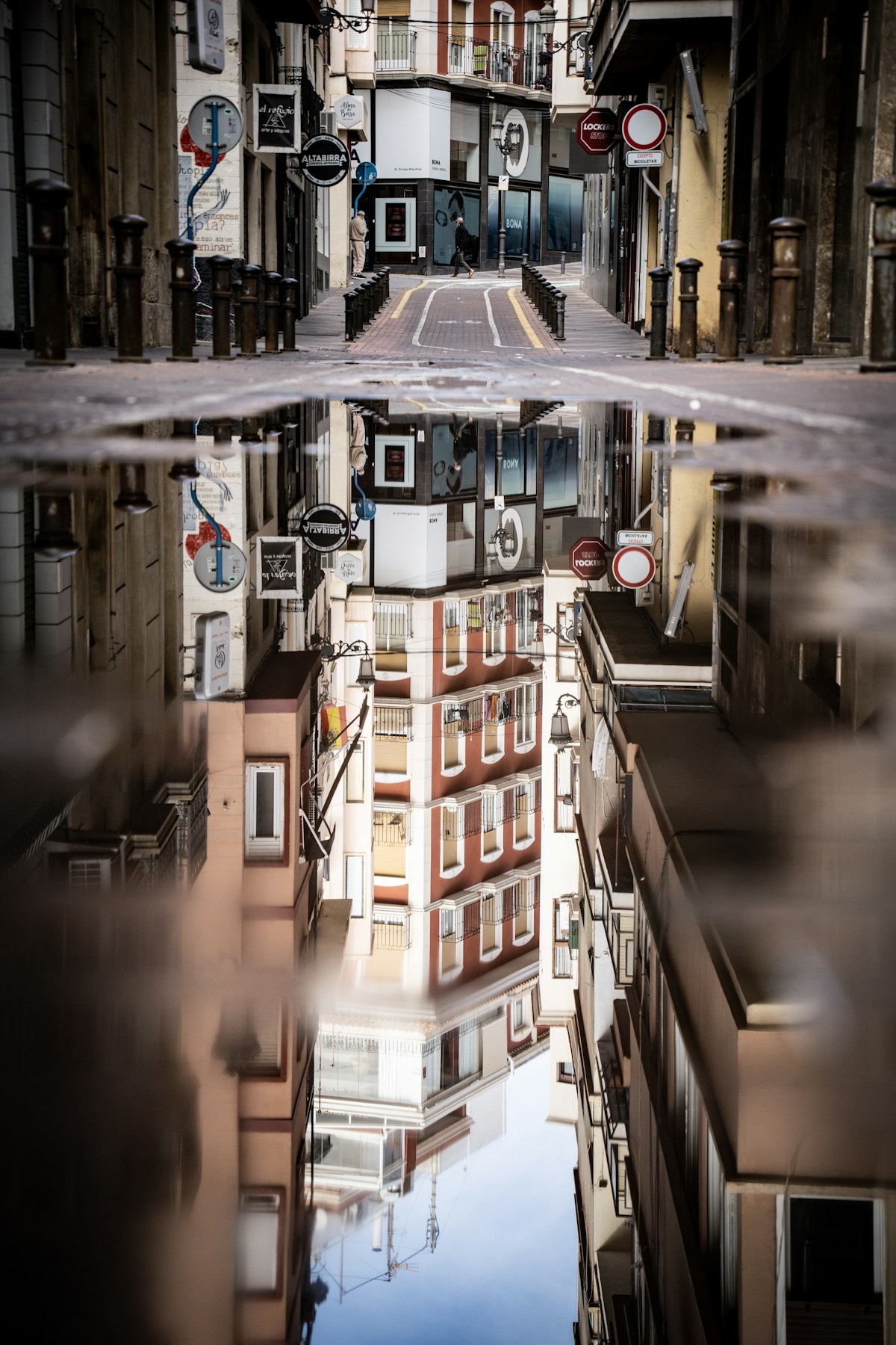 Buildings reflected in a wet street after rain